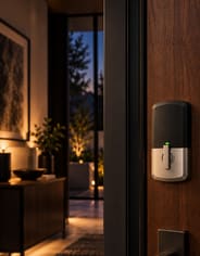 The interior thumbturn of a brass smart lock.